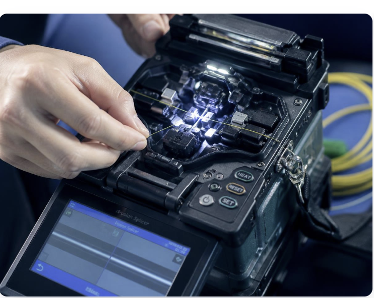 Close-up of fiber optic fusion splicing on a worksite